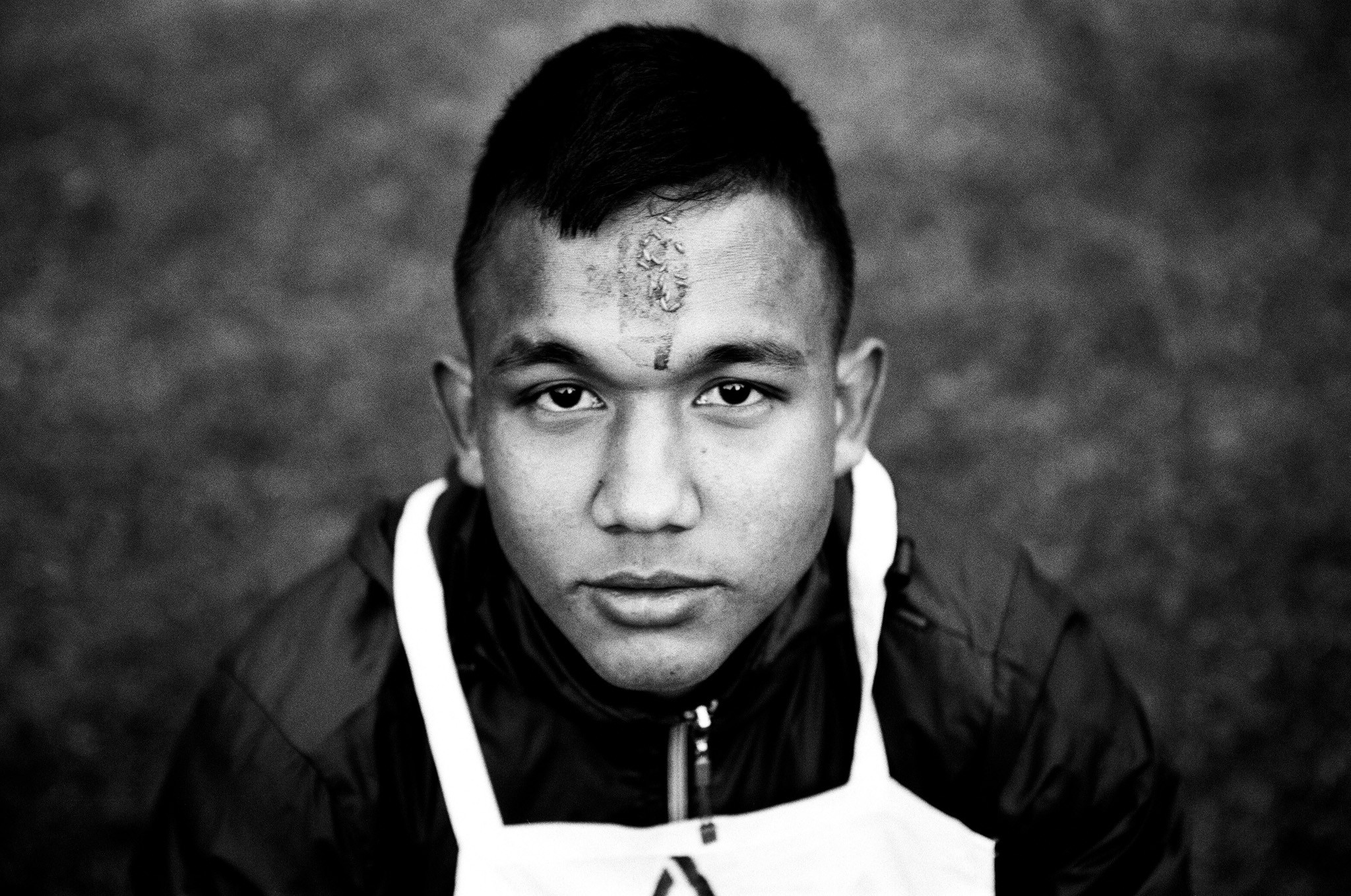 A young hopeful on the first day of the 2nd stage, the central selection in Pokhara, west Nepal. The mark on his forehead is called a tikka. It was put there by his parents for good luck